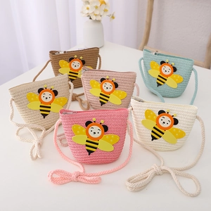 Detail of colorful woven cross-body kids bags featuring cute 3D cartoon bee ornaments