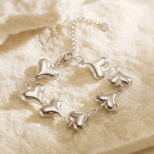 Polished silver heart bracelet in stainless steel with adjustable lobster clasp on stone