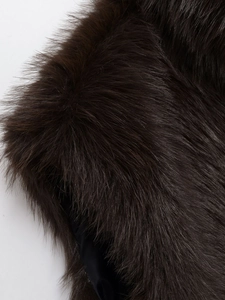 Detailed close-up showing the soft texture and fibers of a dark brown faux fur vest