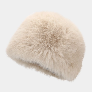 Macro shot of fluffy cream faux fur winter bucket hat with soft texture and dark lining