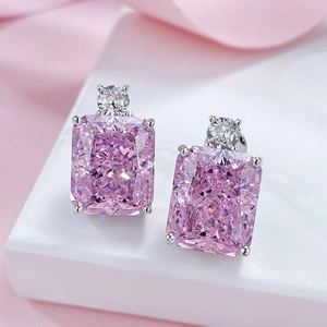 Detail of pink radiant cut gemstone earrings with silver base and top clear accent stone