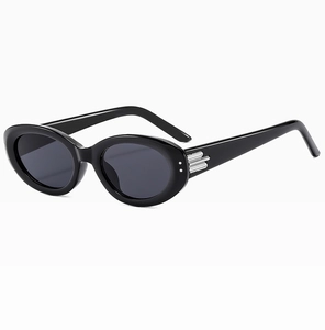 Detailed side view of black oval sunglasses featuring silver metal hinge accents