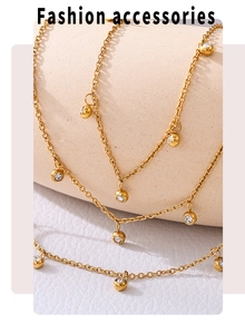 Macro detail of gold beaded anklet with clear zircons on minimalist metal chain