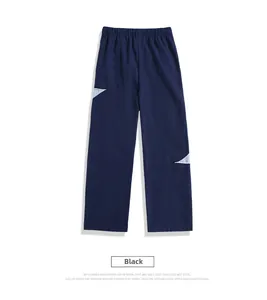 Detail of navy casual trousers with elastic waist and side geometric patchwork design