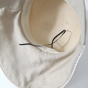 Women's straw sun hat with wide brim, featuring internal sweatband and adjustable drawstring