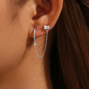 Macro shot of S925 sterling silver chain earrings with cubic zirconia on a model ear
