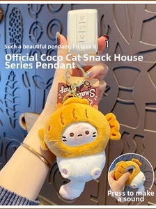 Close-up of white cat plush in orange fish bun with a squeeze squeak function