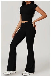 Detail showing the crossover high waist and flared leg of black recycled yoga set
