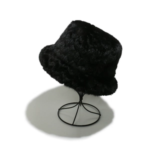 Close-up of black faux mink fur bucket hat texture and dense winter plush material