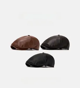Three vintage leather ivy caps in dark brown and black colors on white background