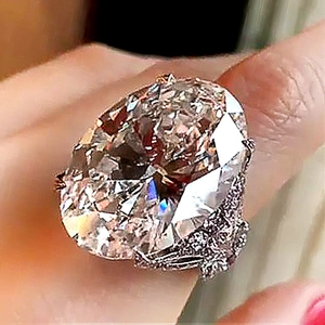 Luxurious silver ring with large oval zircon and butterfly accent worn on hand