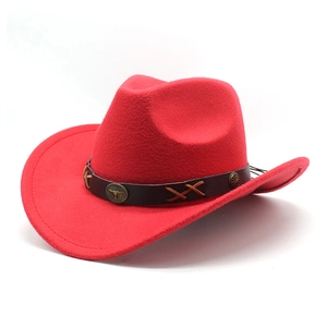 Detail of red wool felt cowboy hat featuring a vintage metal bull head emblem and leather band