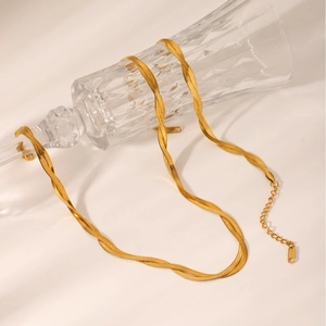 Detail of 18K gold plated herringbone chain wrapped on glass with lobster clasp
