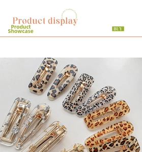 Close-up of leopard print acrylic hair clips set with gold and silver leaf details