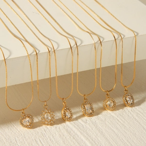 Detailed display of six gold stainless steel necklaces with various geometric pendants