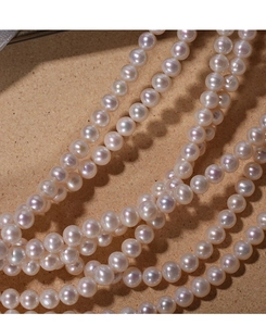 Macro detail of 7mm natural freshwater pearl strands with high luster for DIY jewelry