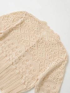 Macro shot of geometric diamond crochet knit texture and wavy neckline edge