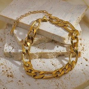 Detail of 18K gold-plated stainless steel Figaro chain bracelet with lobster clasp