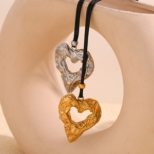 Hammered textured heart necklace in 18K gold and silver plating on black cord