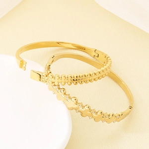Vintage style gold-plated bangles with four-leaf clover pattern and beaded texture