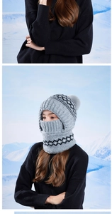 Detail of grey winter knit hooded scarf with warm lining and soft pom-pom decoration