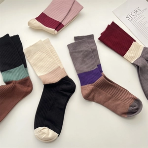 Flat lay of colorful ribbed knit cashmere socks with stylish color-blocking design