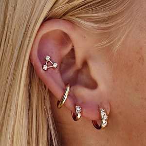 S925 silver gold star hoop earrings set with zircon stones on a female model