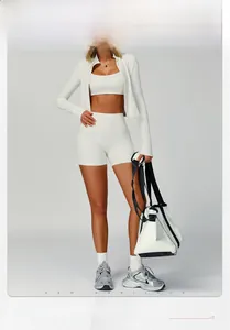 Detailed view of white ribbed three-piece yoga set including jacket, bra and high waist shorts