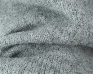 Macro shot of high-quality grey knit fabric with soft mohair texture and ribbed details
