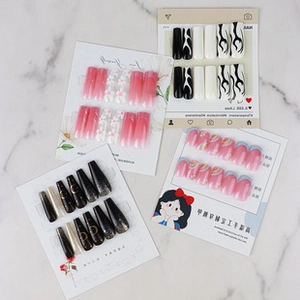 Detail shot of multiple press-on nail sets including 3D floral and flame designs