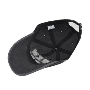 Detail view of cotton baseball cap interior featuring metal buckle and washing label