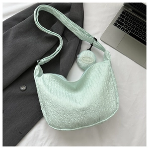 Detail of light green puckered fabric shoulder bag with small fashion coin purse