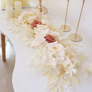 Floral table runner with cream and pink roses, gold leaves on white wedding table