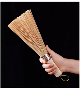 Detail of durable bamboo pot brush with fine bristles and wooden handle with yellow lanyard