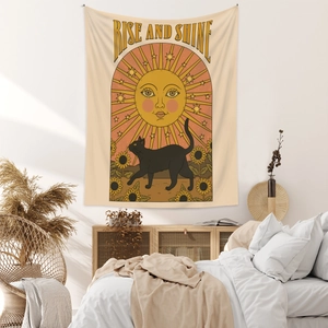 Detail of bohemian wall tapestry with black cat, sunflowers and Rise and Shine text