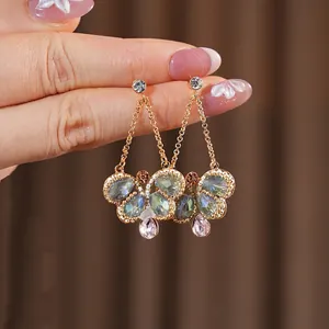 Vintage gold drop earrings with colorful gemstones and butterfly tassel pendants