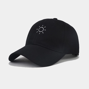 Detailed view of sun embroidery on a black cotton baseball cap with premium stitching