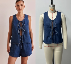 Detail of dark blue denim two-piece set featuring bow tie vest and elastic waist shorts