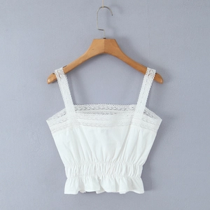 Detailed close-up of white lace camisole featuring elastic waist and ruffled hem