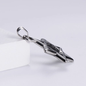 Detail view of mirror polished stainless steel hexagram pendant on geometric cube