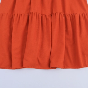 Elegant orange V-neck maxi dress with pleated tiered hem and soft cotton fabric