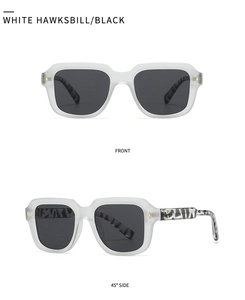 Detail of white matte sunglasses with tortoiseshell temples and golden diamond accents
