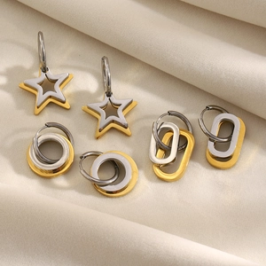 Detailed shot of three pairs of interlocking star and circle earrings in gold and silver