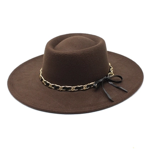 Detail of dark coffee wool felt fedora with metallic chain and black ribbon bow accent
