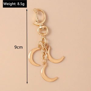 Detail view of gold alloy crescent moon keychain with weight 8.5g and length 9cm specs