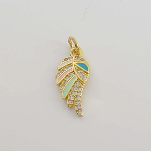 Macro view of gold-plated feather wing charm with colorful enamel and clear zircons