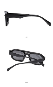 Detail view of double bridge pilot sunglasses with black frame and dark grey lenses