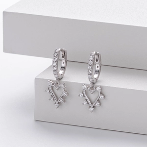 Macro detail of S925 silver heart drop earrings with shimmering white zircon stones