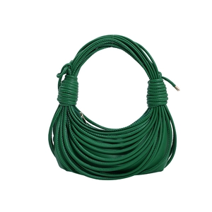 Vibrant green woven knot shoulder bag with textured rope design and crescent hobo shape
