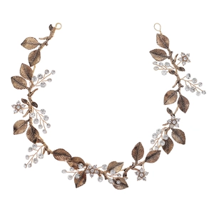 Elegant gold bridal headband with metallic leaves, crystal flowers and rhinestones